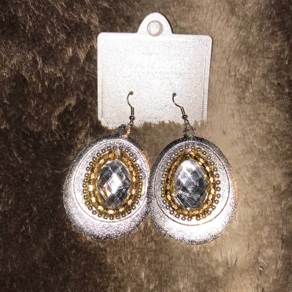 Gold and silver earrings with center stone.